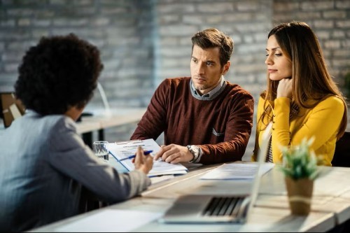 Credit counselor talking to couple to repair credit